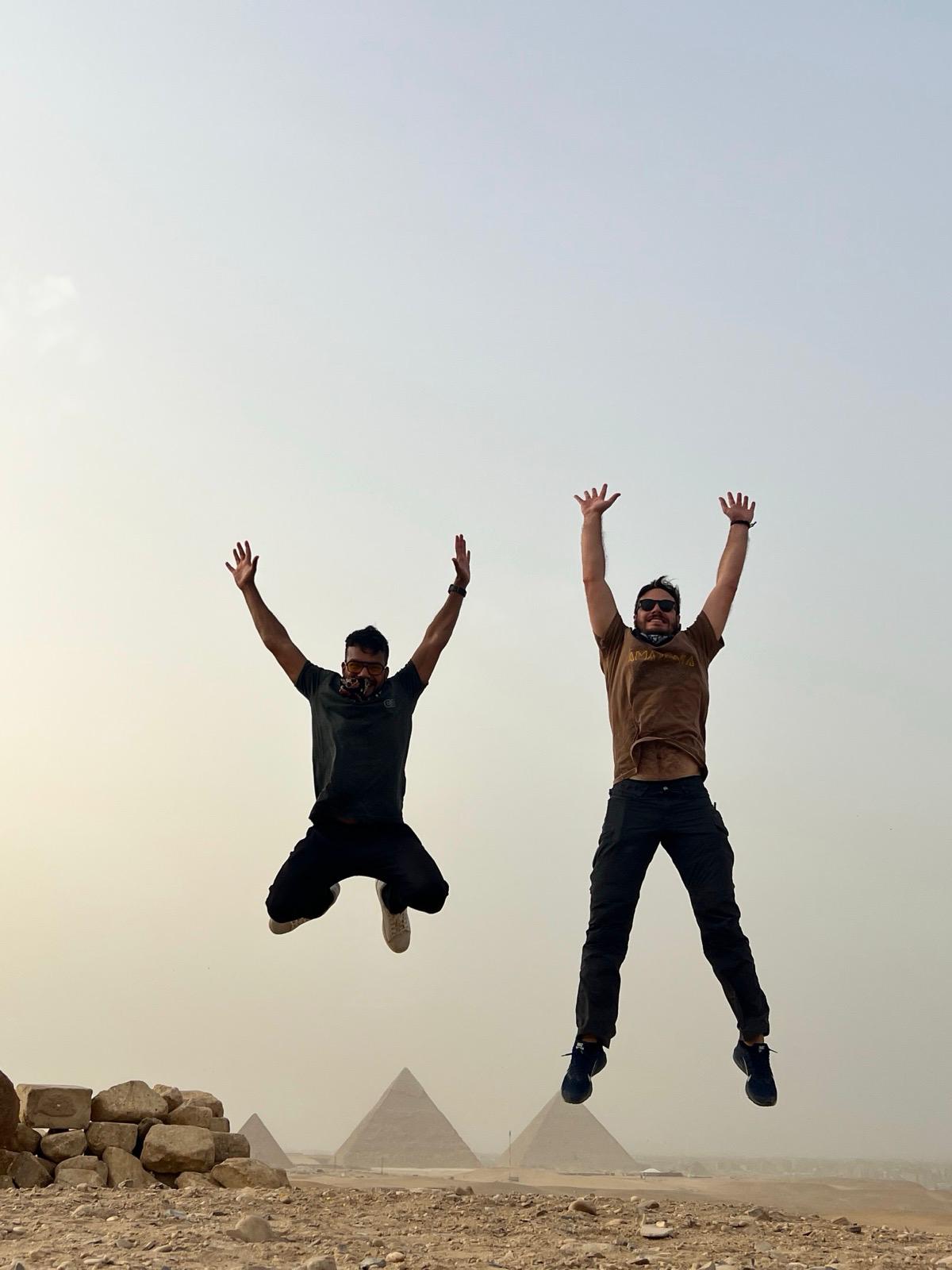 Andrea and Ryan jumping at the pyramids